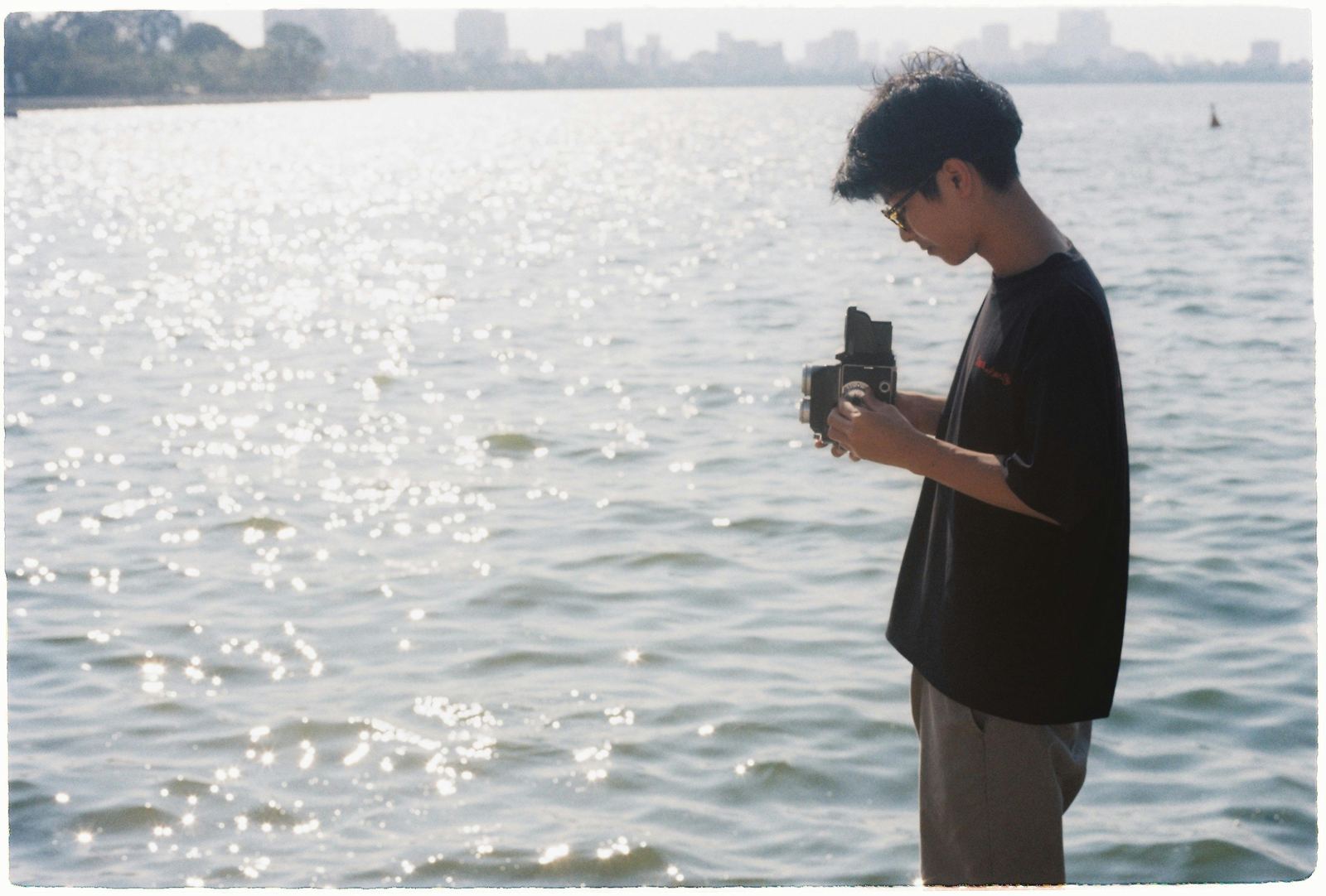 Photographer holding a film camera outdoors
