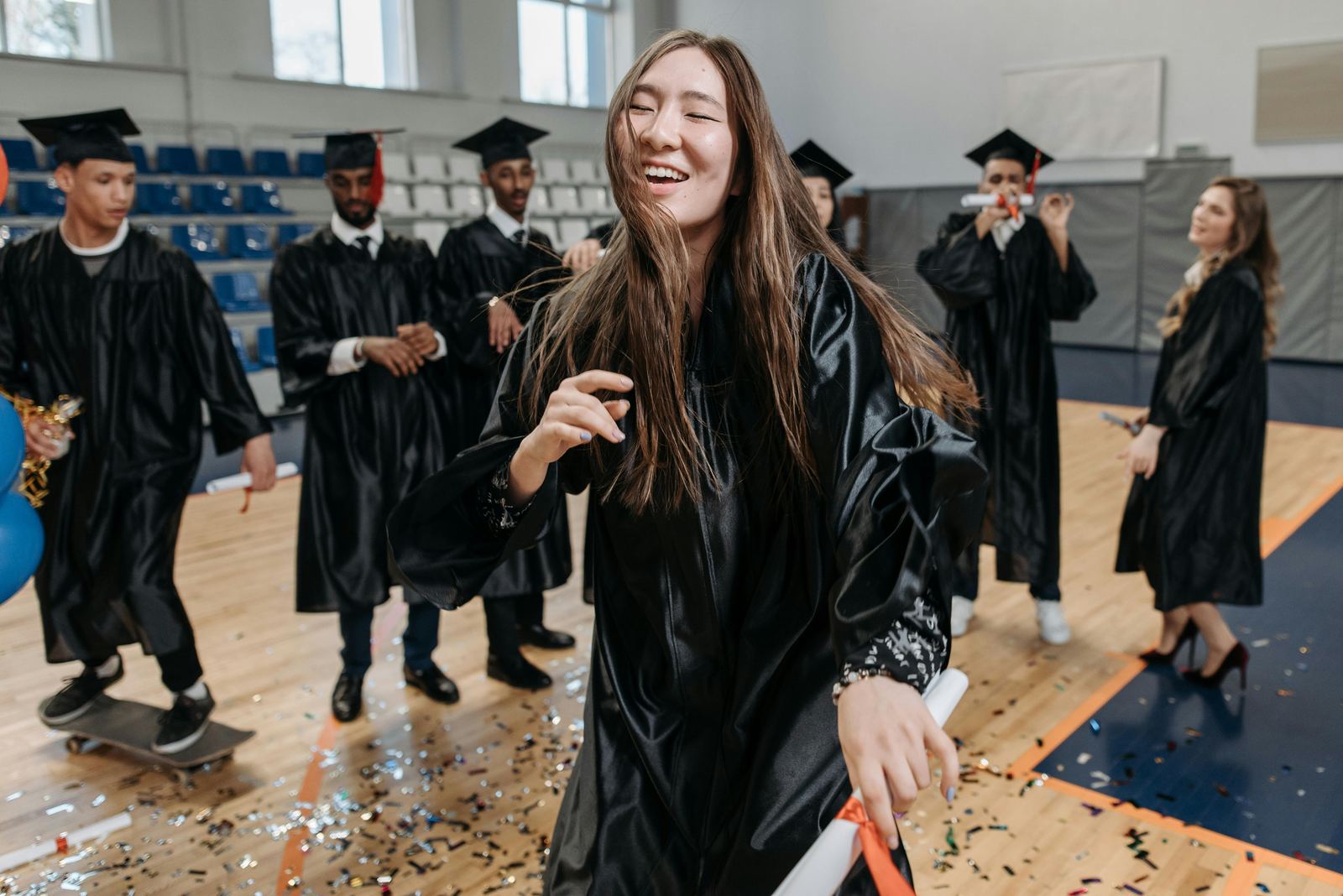 Graduate celebrating with confetti